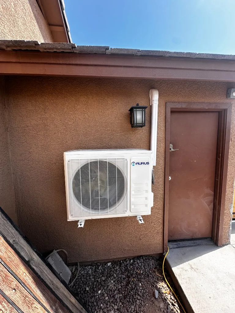 Outdoor mini-split condenser with refrigerant line routing
