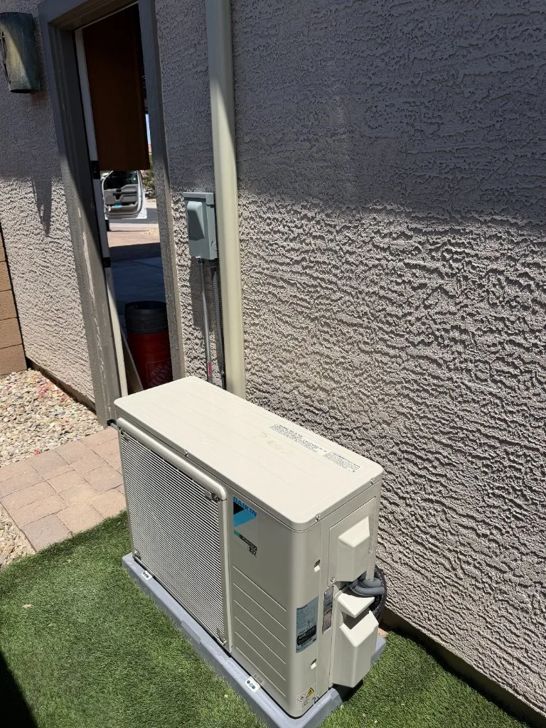 Outdoor mini-split condenser with refrigerant line routing
