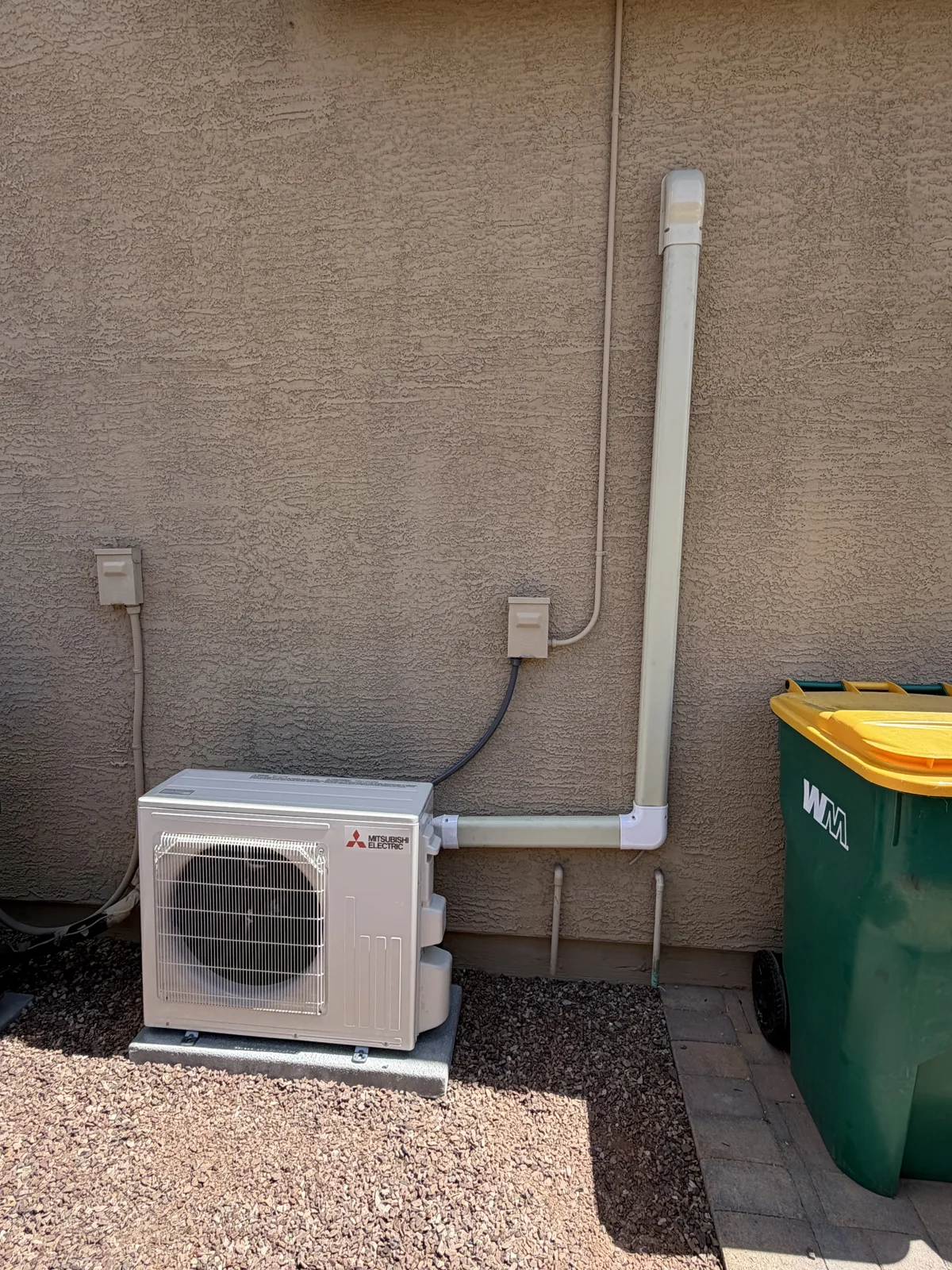 Outdoor mini-split condenser with refrigerant line routing
