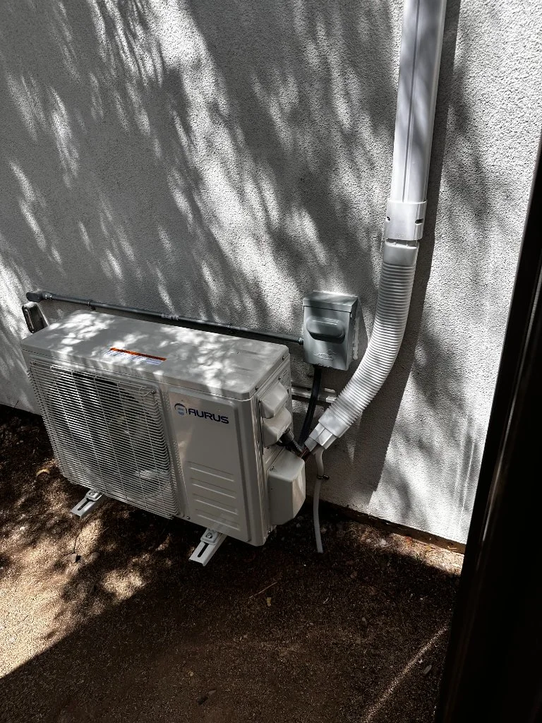 Outdoor mini-split condenser with refrigerant line routing