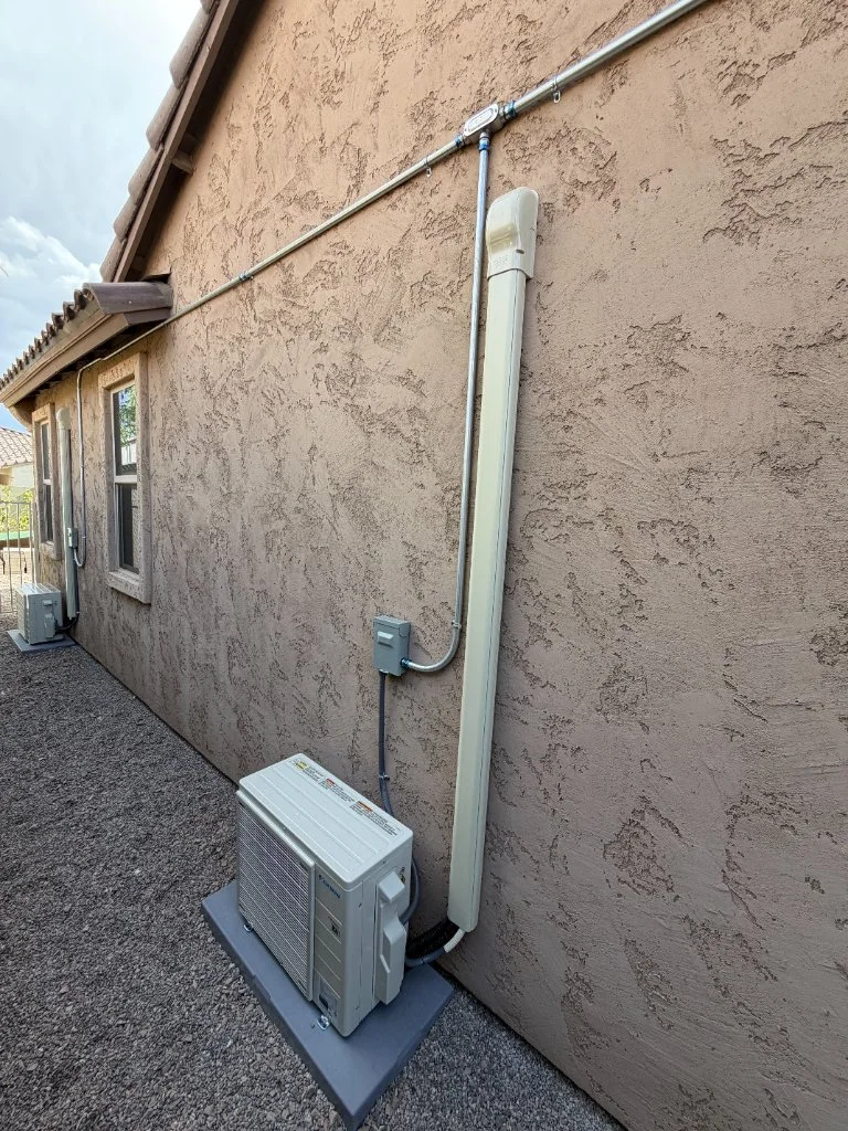 Outdoor mini-split condenser with refrigerant line routing
